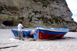 Fishing boats on the white sand of Tropea, on the west coast of Calabria, Italy